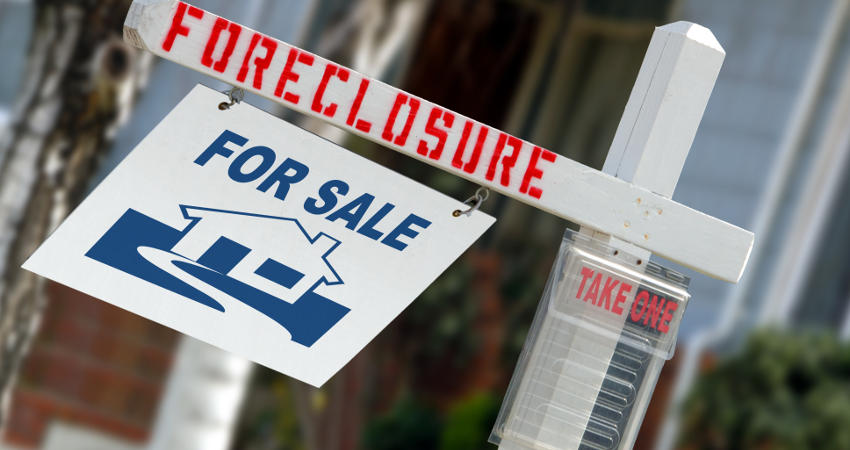 Foreclosure sign on house front yard